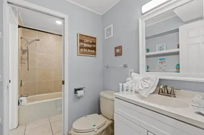 a bathroom with a toilet and a sink and a shower at The Summit 1409 in Panama City Beach