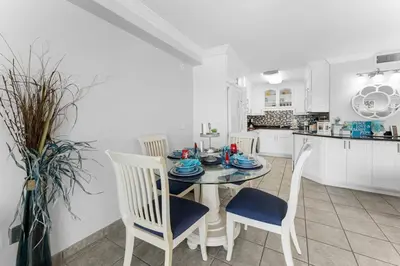 a kitchen and dining room with a table and chairs at The Summit 1130 in Panama City Beach