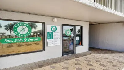 a store with a sign on the side of a building at The Summit 1130 in Panama City Beach