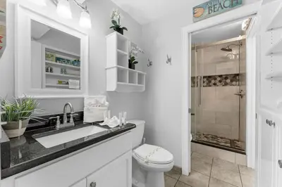 a white bathroom with a sink and a toilet at The Summit 1130 in Panama City Beach