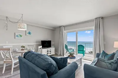 a living room with a couch and a dining room with a view at The Summit 515 in Panama City Beach