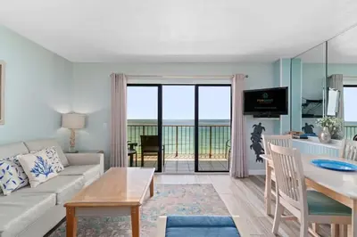 a living room with a couch and a table at The Summit 1030 in Panama City Beach