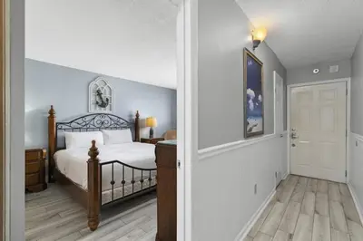 a bedroom with a bed and a hallway with a door at The Summit 728 in Panama City Beach