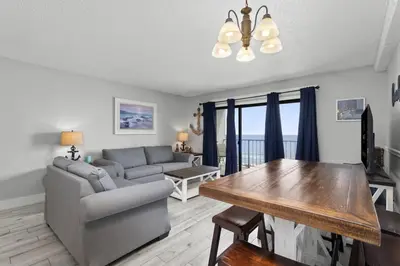 a living room with a couch and a table at The Summit 728 in Panama City Beach
