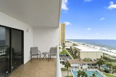a balcony with a view of the beach and the ocean at The Summit 728 in Panama City Beach