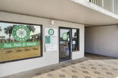 a store with a sign on the side of a building at The Summit 728 in Panama City Beach