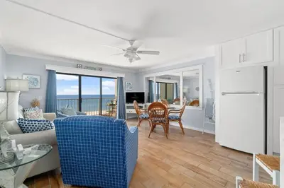 a living room with a couch and a table at The Summit 502 in Panama City Beach