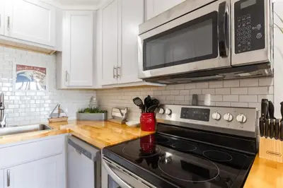 a kitchen with a stove and a microwave at The Summit 504 in Panama City Beach