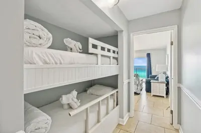 a childs bedroom with two bunk beds and a doorway at The Summit 1017 in Panama City Beach