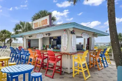 a bar with colorful chairs and tables at the beach at The Summit 1017 in Panama City Beach
