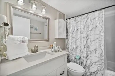 a bathroom with a sink and a toilet and a shower at Moondrifter 502 in Panama City Beach
