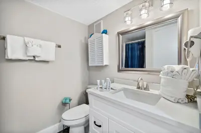 a white bathroom with a sink and a toilet at Moondrifter 502 in Panama City Beach