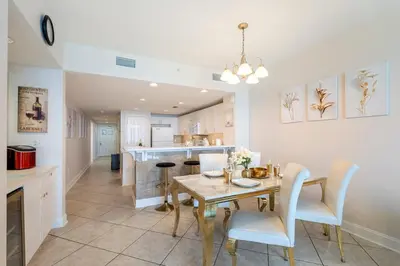 a kitchen and dining room with a table and chairs at Majestic T2 - 1606 in Panama City Beach