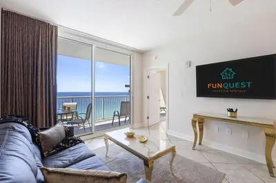a living room with a couch and a view of the ocean at Majestic T2 - 1606 in Panama City Beach