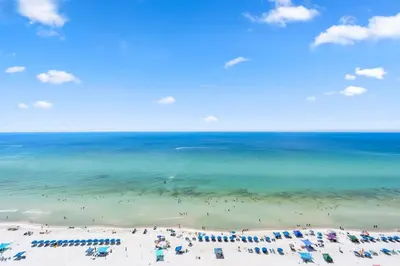 a view of a beach with chairs and the ocean at Majestic T2 - 1606 in Panama City Beach