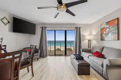 a living room with a couch and a ceiling fan at The Summit 531 in Panama City Beach
