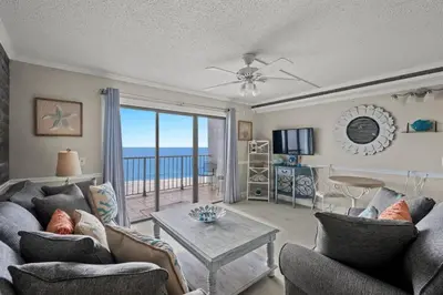 a living room with a view of the ocean at The Summit 816 in Panama City Beach