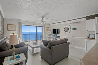 a living room with a view of the ocean at The Summit 816 in Panama City Beach