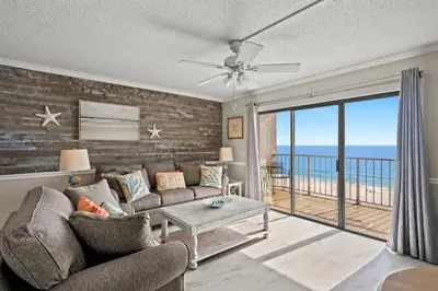 a living room with a couch and a view of the ocean at The Summit 816 in Panama City Beach
