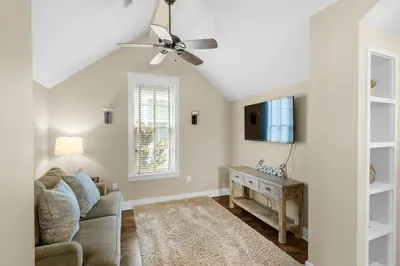 a living room with a ceiling fan and a couch at Sunny Side Up in Santa Rosa Beach