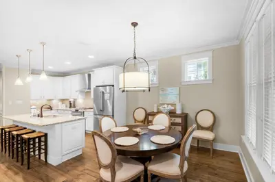 a kitchen and dining room with a table and chairs at Sunny Side Up in Santa Rosa Beach