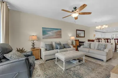 a living room with couches and a ceiling fan at Majestic Beach Towers 2-1708 in Panama City Beach