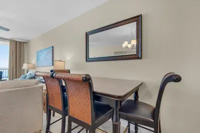 a living room with a table and a couch at Majestic Beach Towers 2-1708 in Panama City Beach