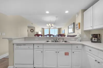 a kitchen with white cabinets and a sink at Majestic Beach Towers 2-1708 in Panama City Beach