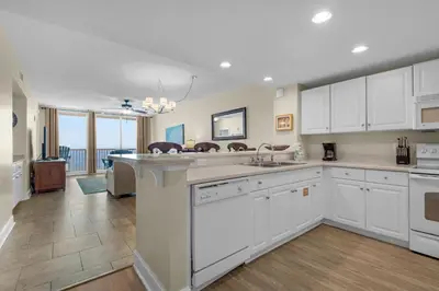 a large kitchen with white cabinets and a kitchen island at Majestic Beach Towers 2-1708 in Panama City Beach