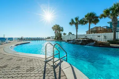 a swimming pool with a stairway leading into a resort at Majestic Beach Towers 2-1708 in Panama City Beach