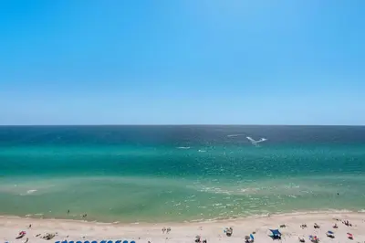 a group of people on a beach near the water at Majestic Beach Towers 2-1708 in Panama City Beach