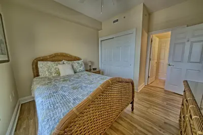 a bedroom with a bed with a wicker bed frame at Luxurious Tropical Condo with Breathtaking Gulf View - Unit 2006 in Panama City Beach
