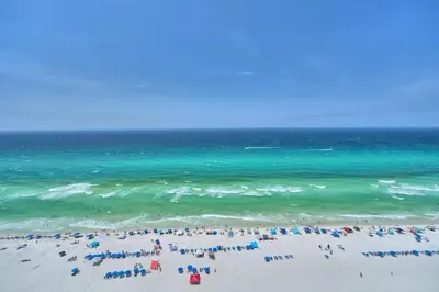 a group of people on a beach with the ocean at Luxurious Tropical Condo with Breathtaking Gulf View - Unit 2006 in Panama City Beach