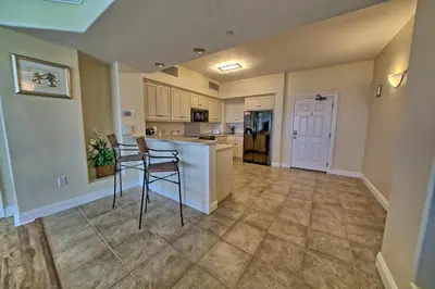 a kitchen with a counter and chairs in a room at Luxurious Tropical Condo with Breathtaking Gulf View - Unit 2006 in Panama City Beach