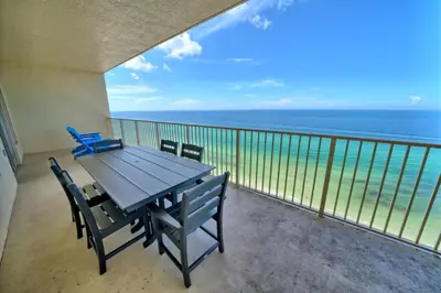 a balcony with a table and chairs and the ocean at Wondrous Condo with Beach Access and Poolside Beach - Unit 2103 in Panama City Beach