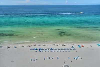 an aerial view of a beach with chairs and umbrellas at Wondrous Condo with Beach Access and Poolside Beach - Unit 2103 in Panama City Beach
