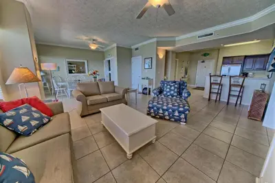 a living room with couches and chairs and a kitchen at Wondrous Condo with Beach Access and Poolside Beach - Unit 2103 in Panama City Beach