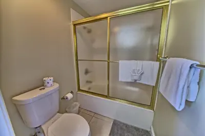 a bathroom with a toilet and a shower with towels at Wondrous Condo with Beach Access and Poolside Beach - Unit 2103 in Panama City Beach