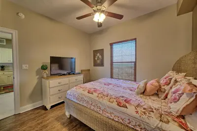 a bedroom with a bed and a flat screen tv at Roomy Oceanfront Condo with Breathtaking View and Beachside Pool - Unit 1906 in Panama City Beach