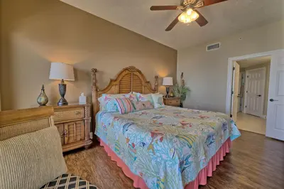 a bedroom with a large bed and a ceiling fan at Roomy Oceanfront Condo with Breathtaking View and Beachside Pool - Unit 1906 in Panama City Beach