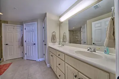 a bathroom with a sink and a large mirror at Roomy Oceanfront Condo with Breathtaking View and Beachside Pool - Unit 1906 in Panama City Beach