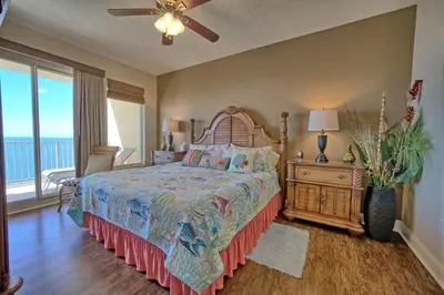 a bedroom with a bed and a large window at Roomy Oceanfront Condo with Breathtaking View and Beachside Pool - Unit 1906 in Panama City Beach