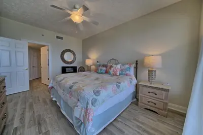 a bedroom with a bed and a ceiling fan at Marvelous Condo with Beachside Pool and Free Poolside WiFi - Unit 0902 in Panama City Beach