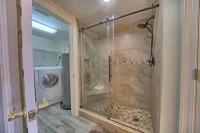 a shower with a glass door in a bathroom at Marvelous Condo with Beachside Pool and Free Poolside WiFi - Unit 0902 in Panama City Beach