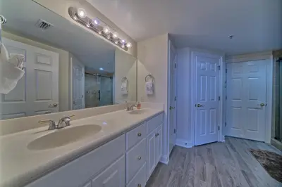a bathroom with a sink and a large mirror at Marvelous Condo with Beachside Pool and Free Poolside WiFi - Unit 0902 in Panama City Beach