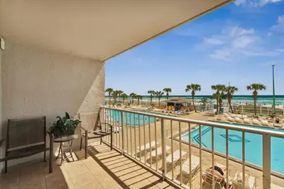 a balcony with a view of the beach and the ocean at The Summit 215 in Panama City Beach