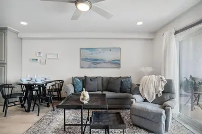 a living room with a couch and a table at The Summit 215 in Panama City Beach