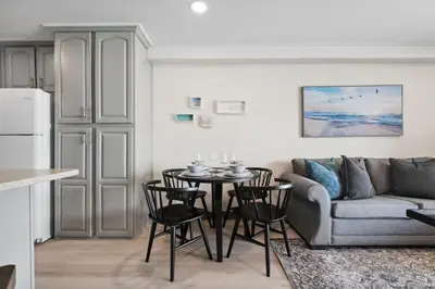 a living room with a couch and a table and chairs at The Summit 215 in Panama City Beach