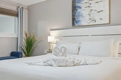 a bedroom with a white bed with a towel on it at The Summit 1217 in Panama City Beach