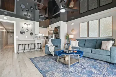 a living room with a blue couch and a table at The Summit 1217 in Panama City Beach